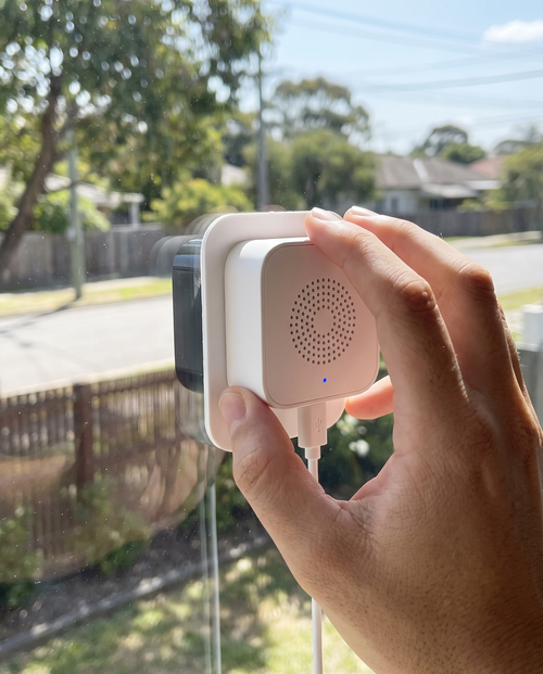 Installing Sill Cam on the inside of a window, rear side visible – AI placeholder